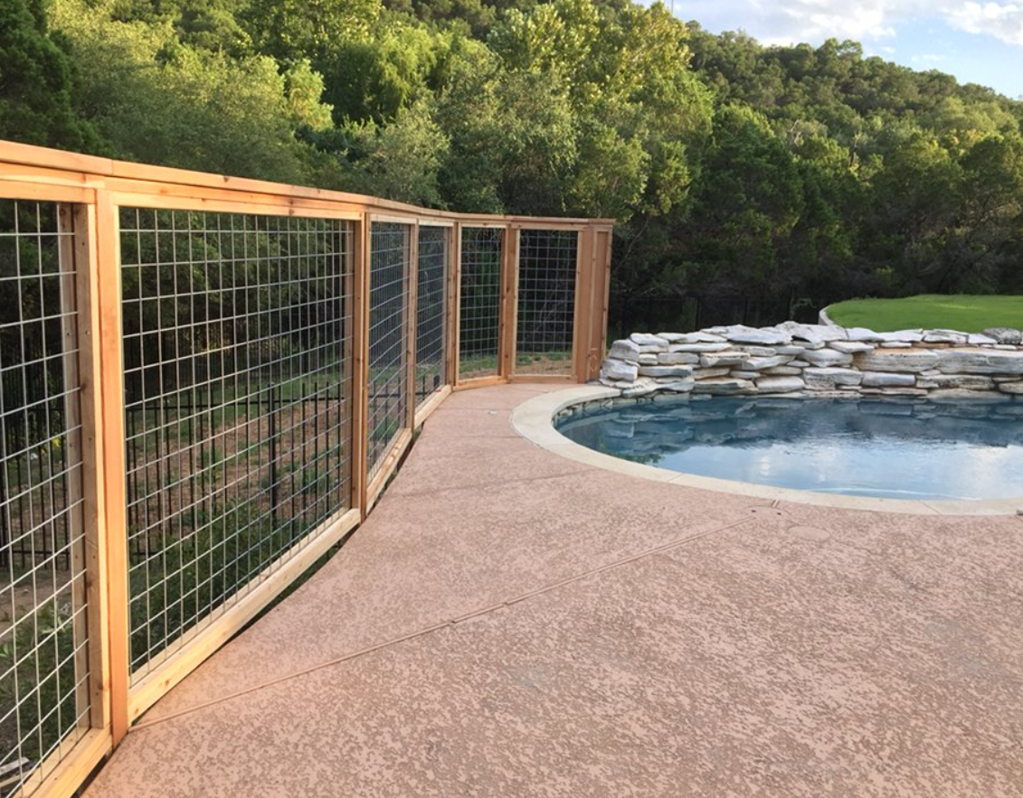 Custom designed Cedar hog wire railing surrounding a pool deck area installed by Sasquatch Deck